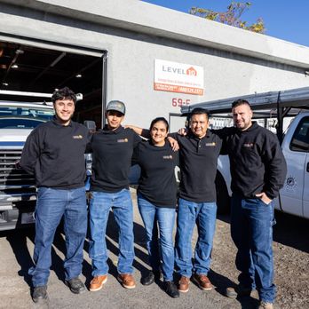 The Level 10 Overhead Door team standing in front of the shop